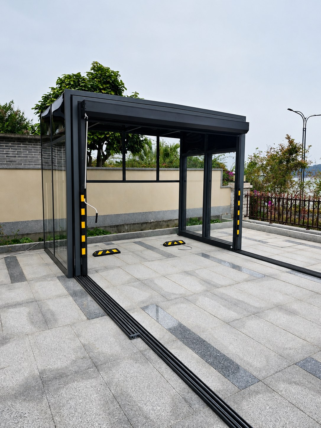 Retractable garage tracks and drainage prepared for aligned movement